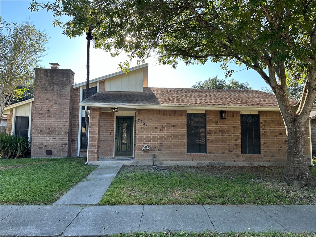 front view of a house with a tree