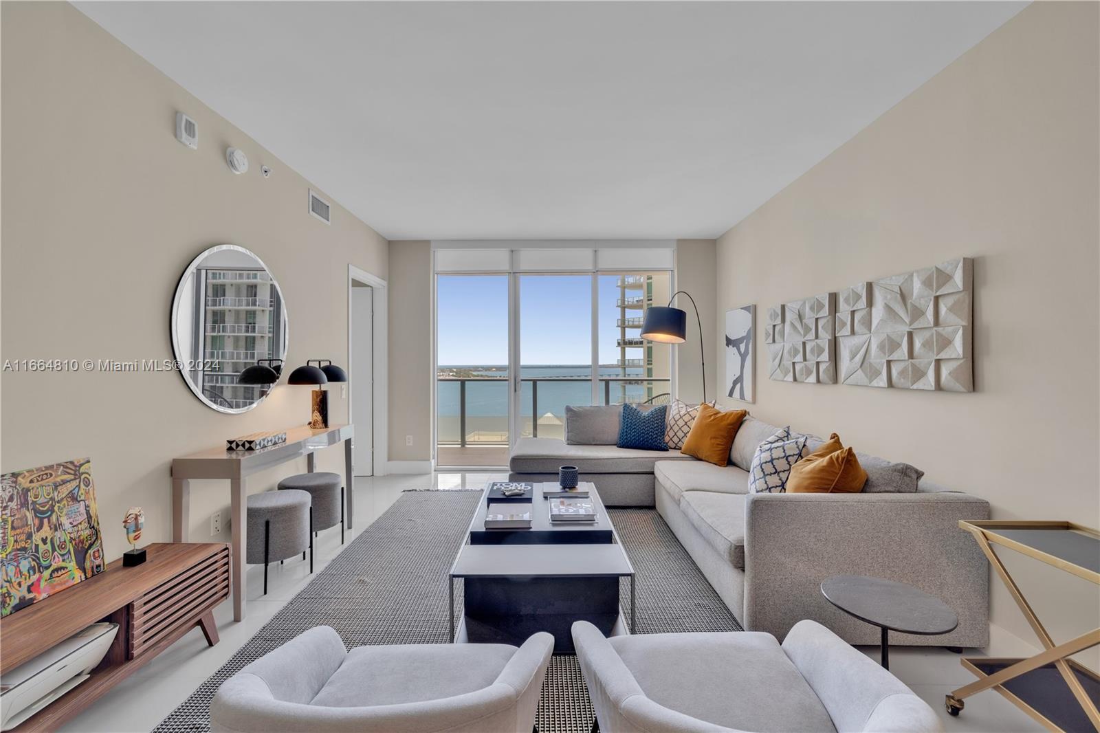 a living room with furniture a rug and a window