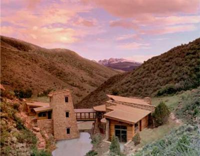 a view of a big house with a mountain in the background