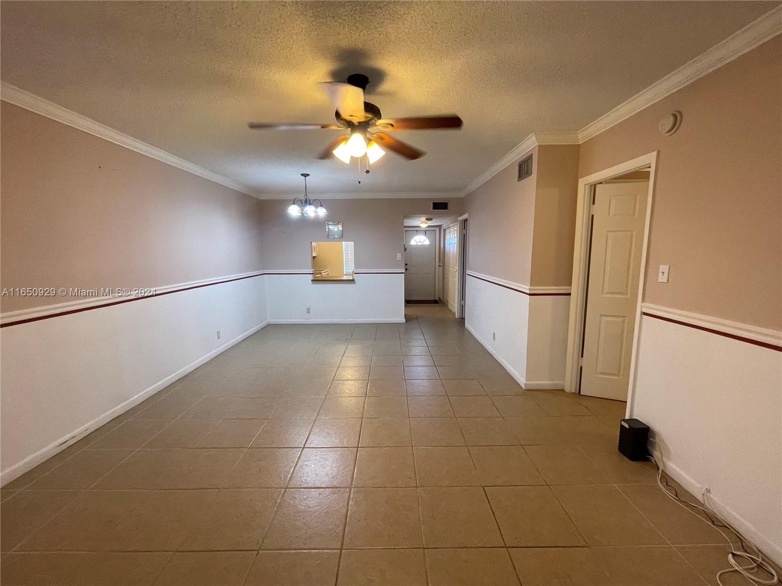 a view of a hallway with a kitchen