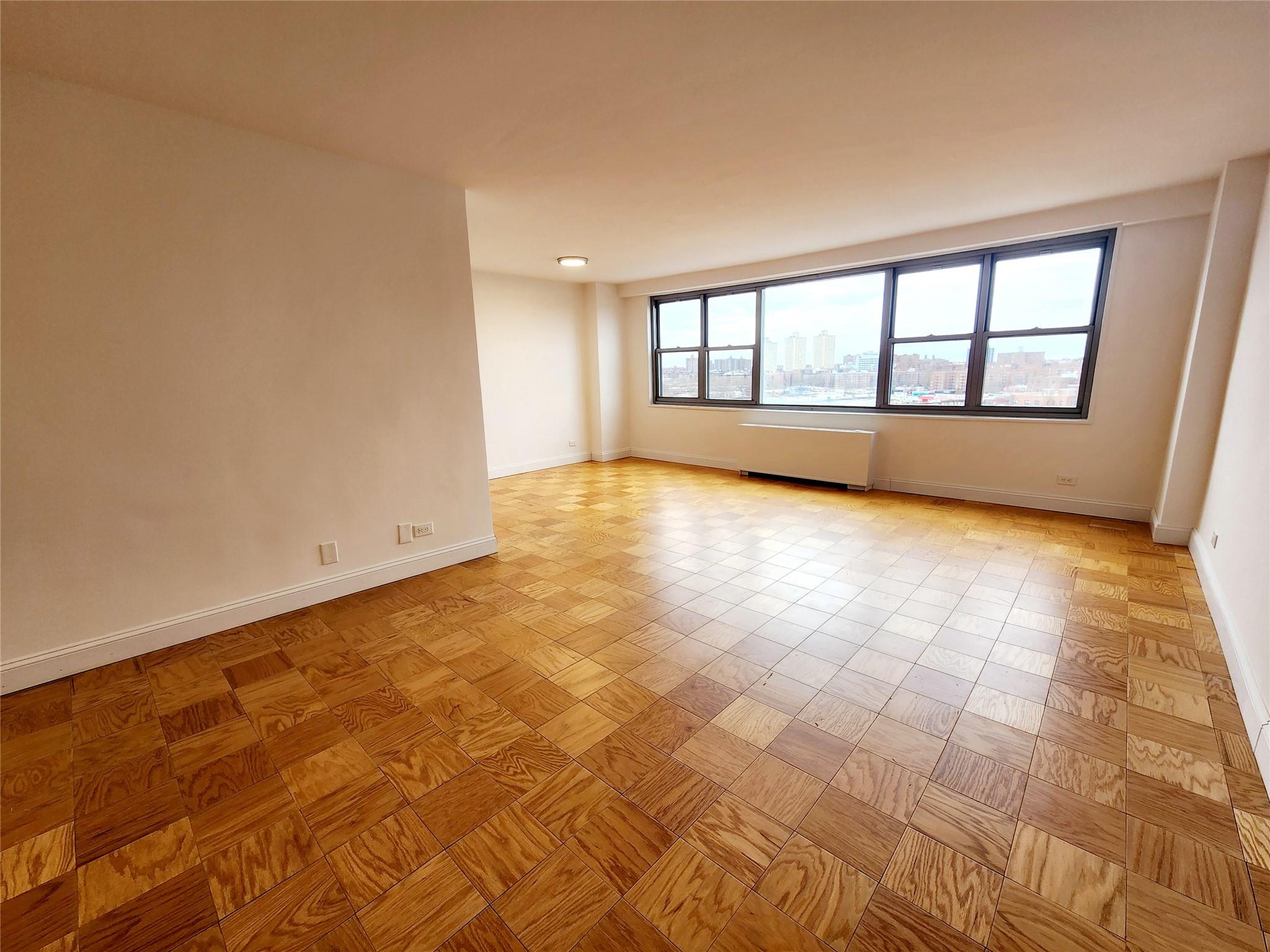 Unfurnished room with radiator and light parquet flooring