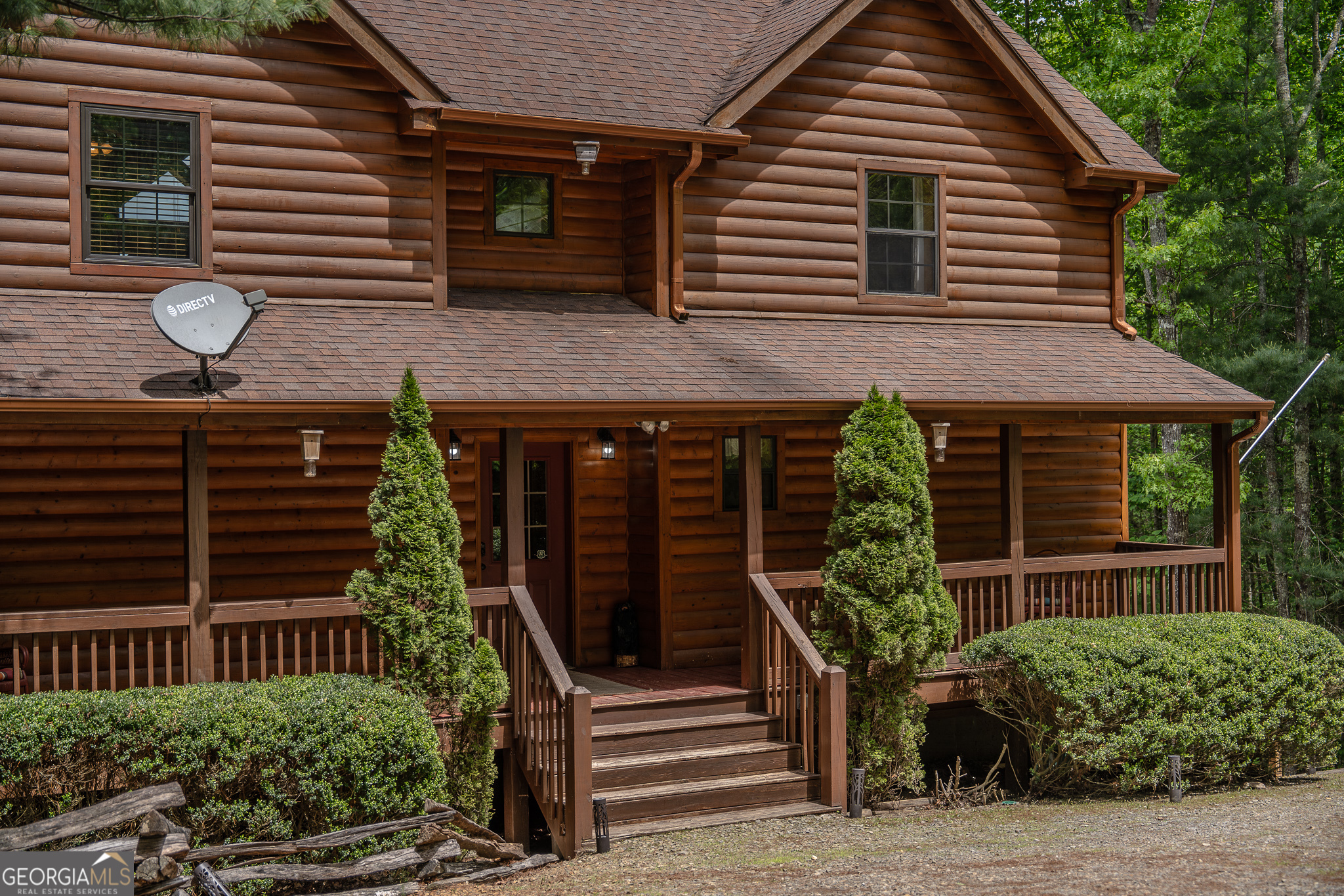 a front view of house with a garden