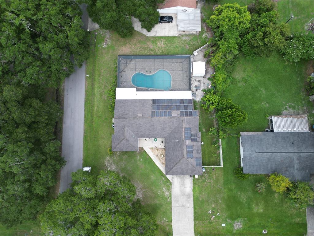 an aerial view of a house with a yard