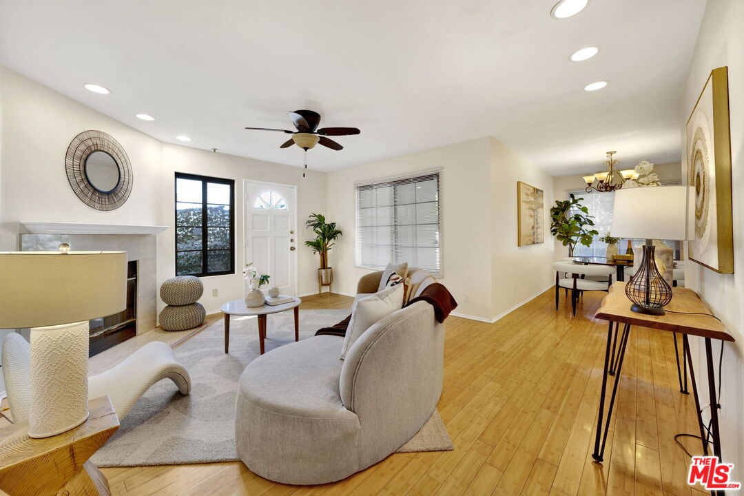 a living room with furniture a rug and a flat screen tv