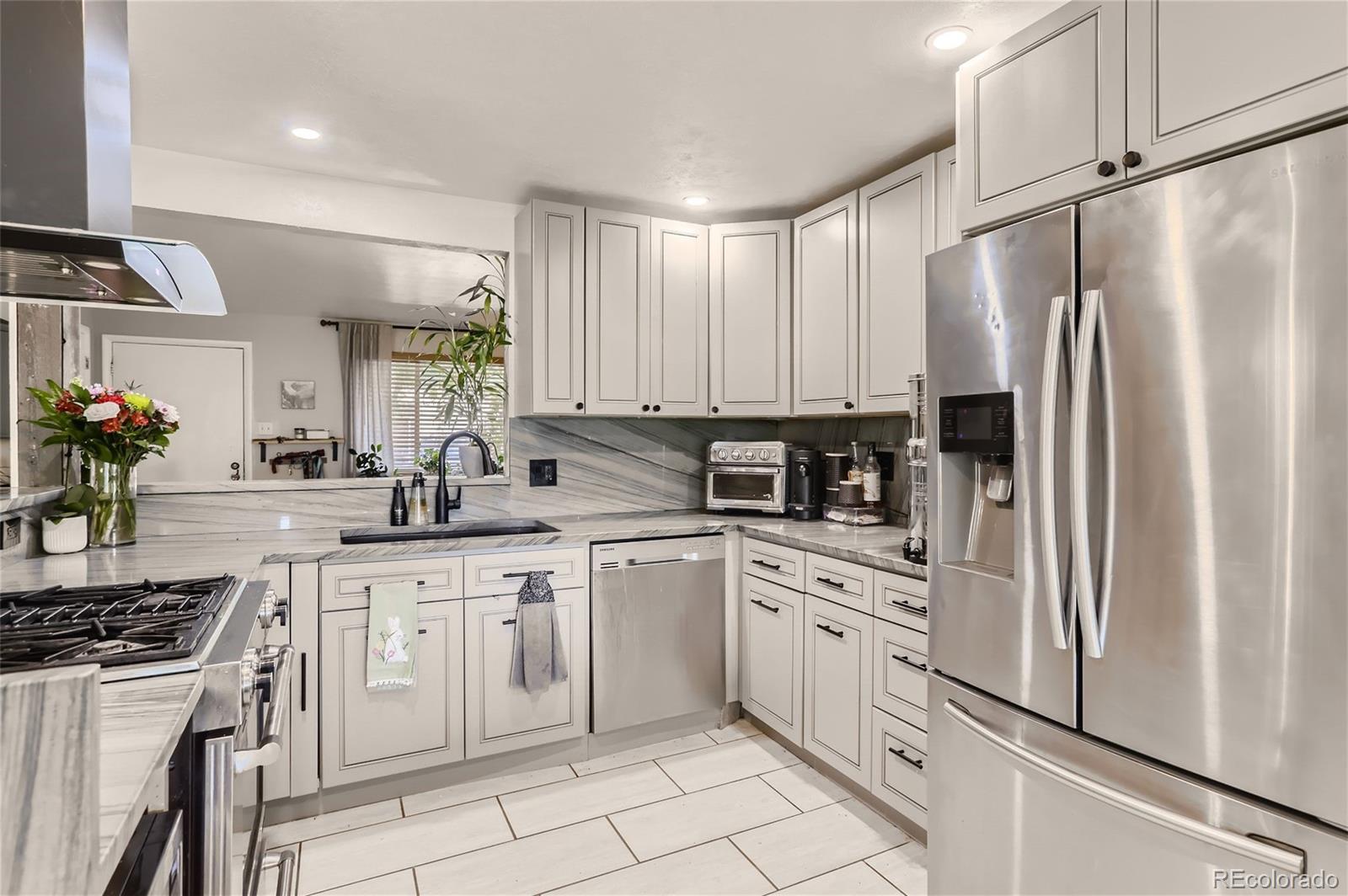 a kitchen with white cabinets and white appliances