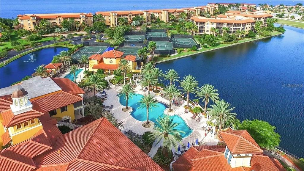 an aerial view of a house with a garden and lake view