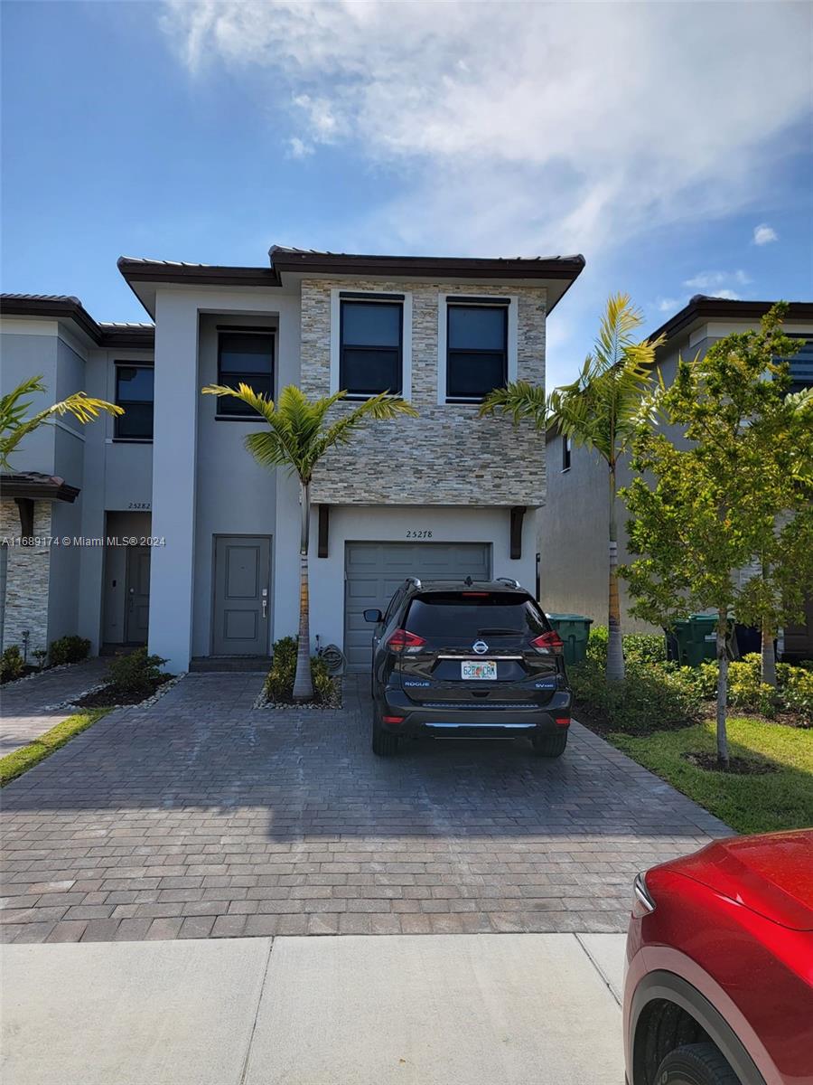 a view of a car parked in front of a house