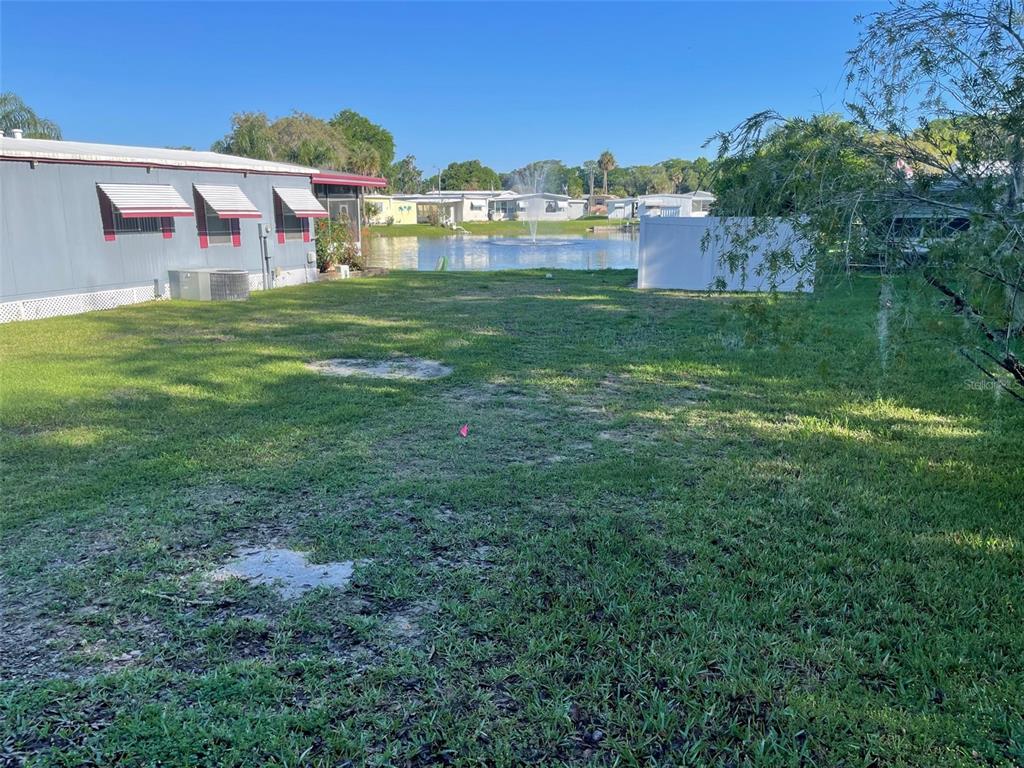 a view of a big yard with a house in the background