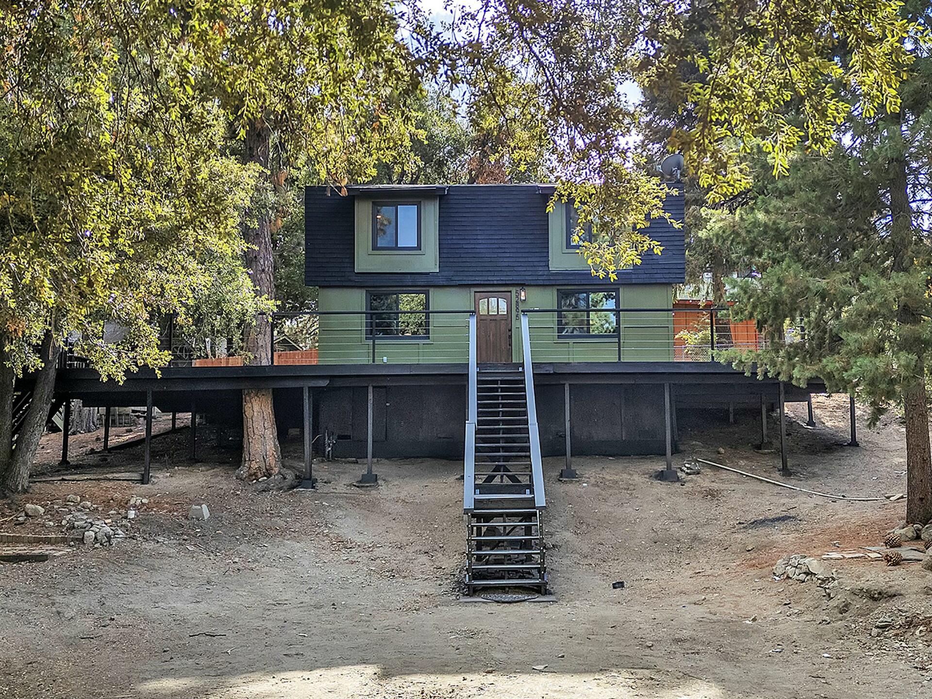 a view of a house with a yard and sitting area