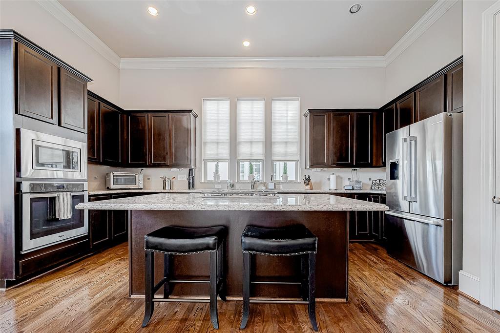 a kitchen with stainless steel appliances a stove a sink and a refrigerator