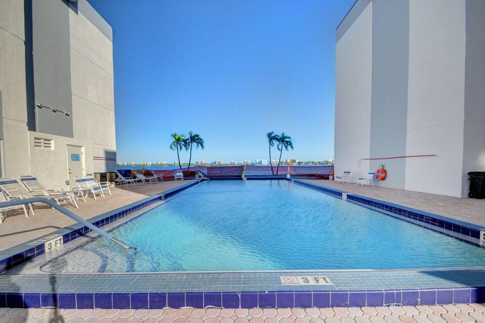 a view of a swimming pool with outdoor seating