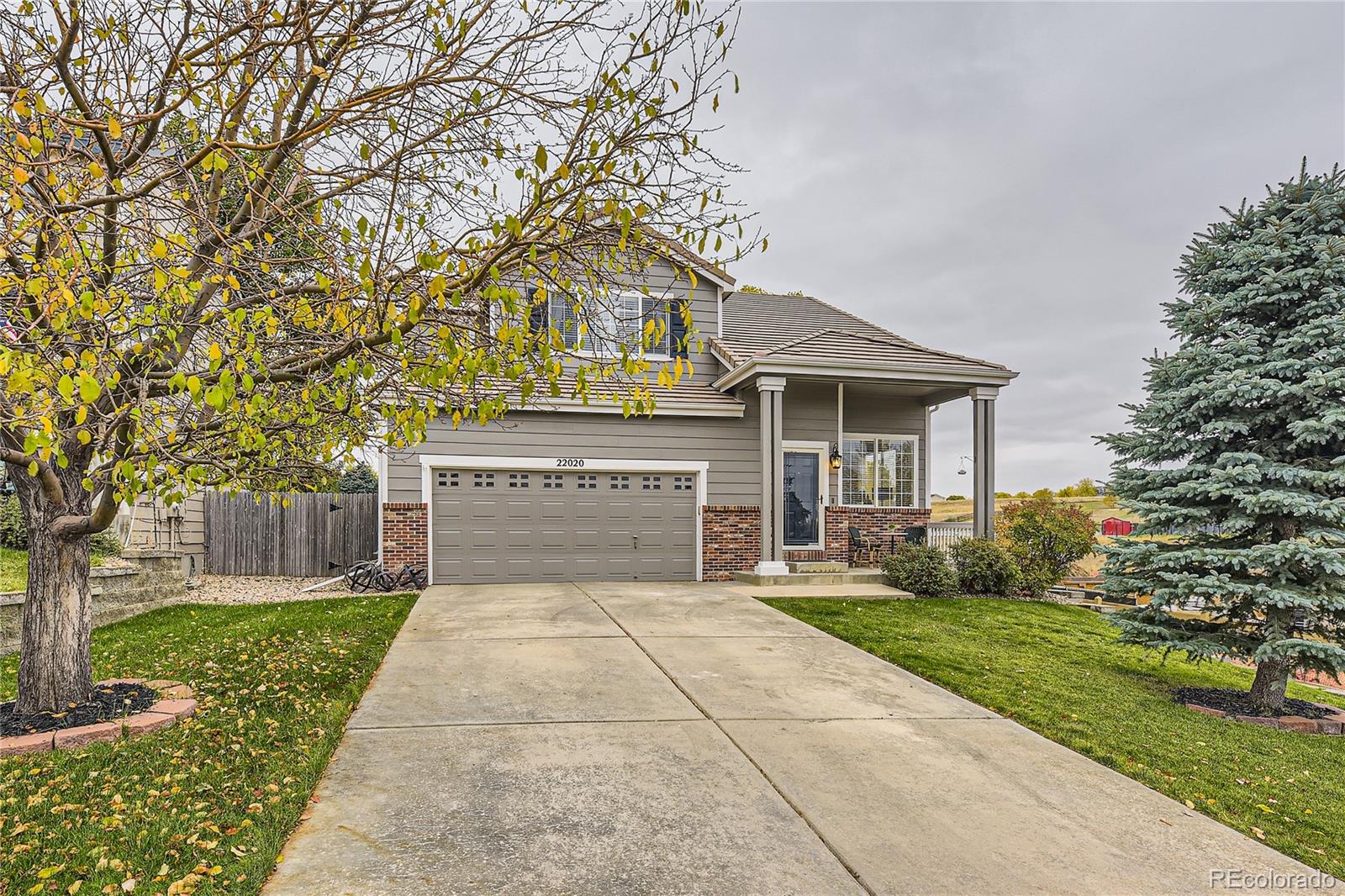 a front view of a house with yard and green space