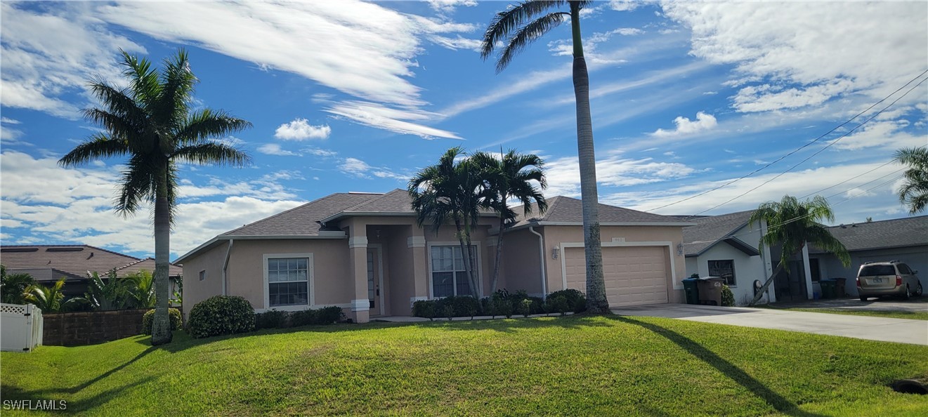 a front view of a house with a yard and garage