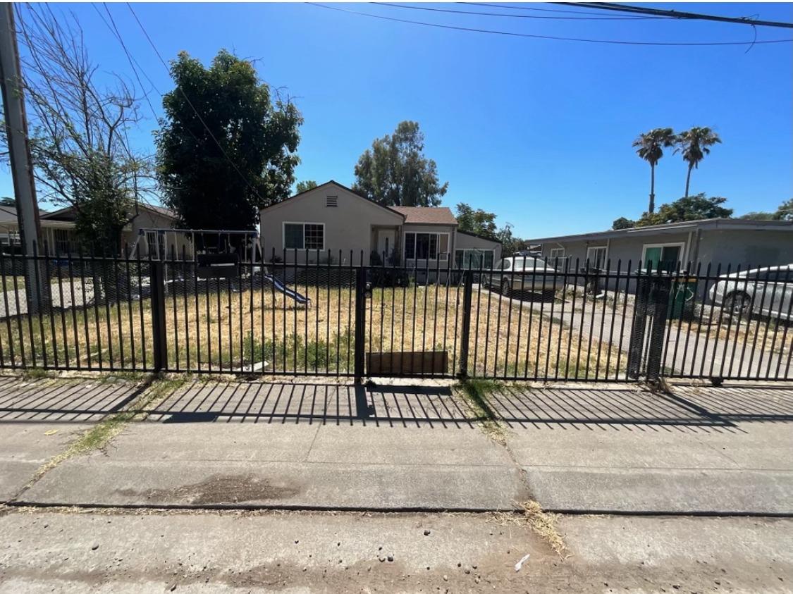 a view of a house with a iron fence