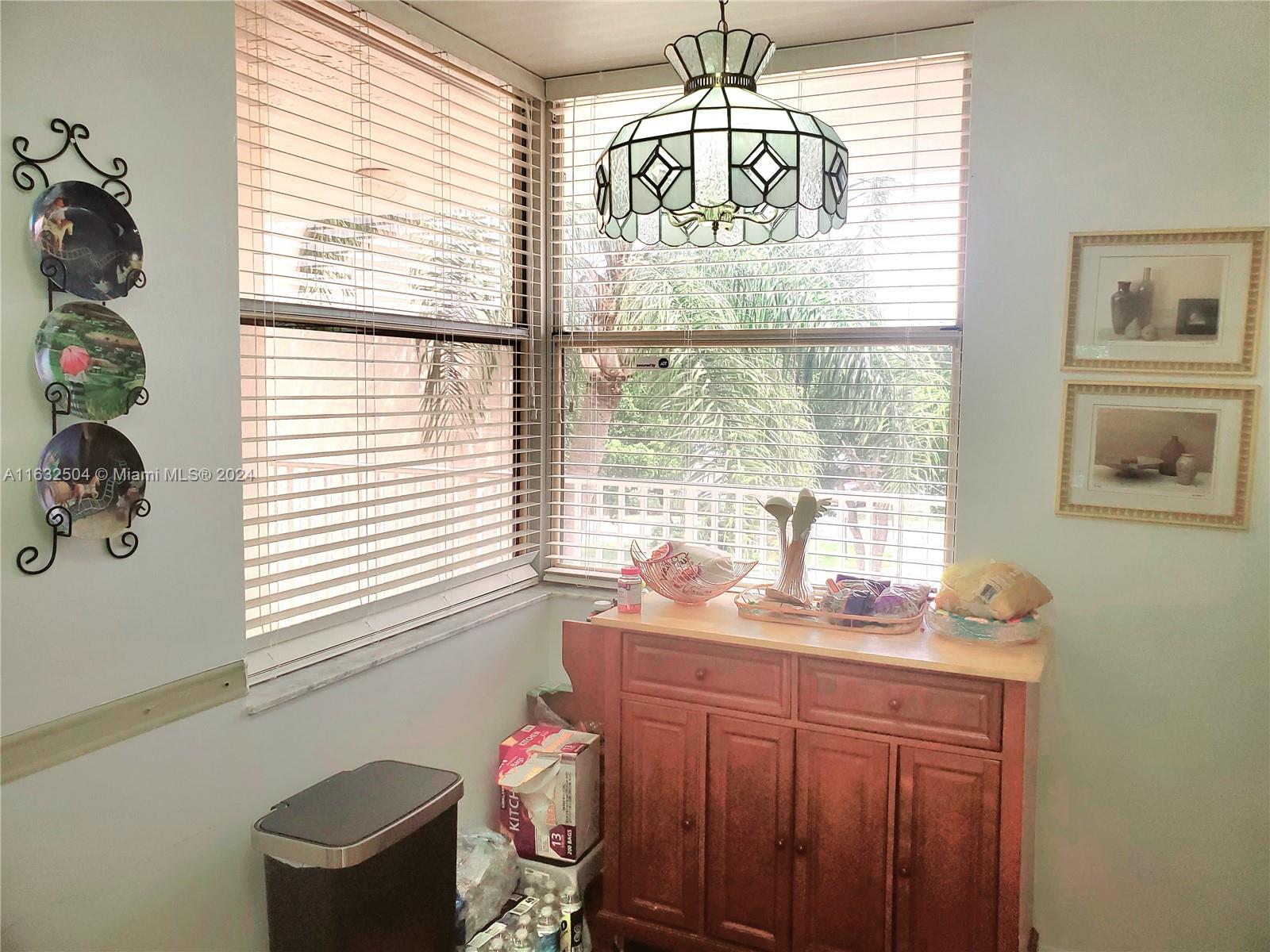 a bathroom with a granite countertop sink and a window