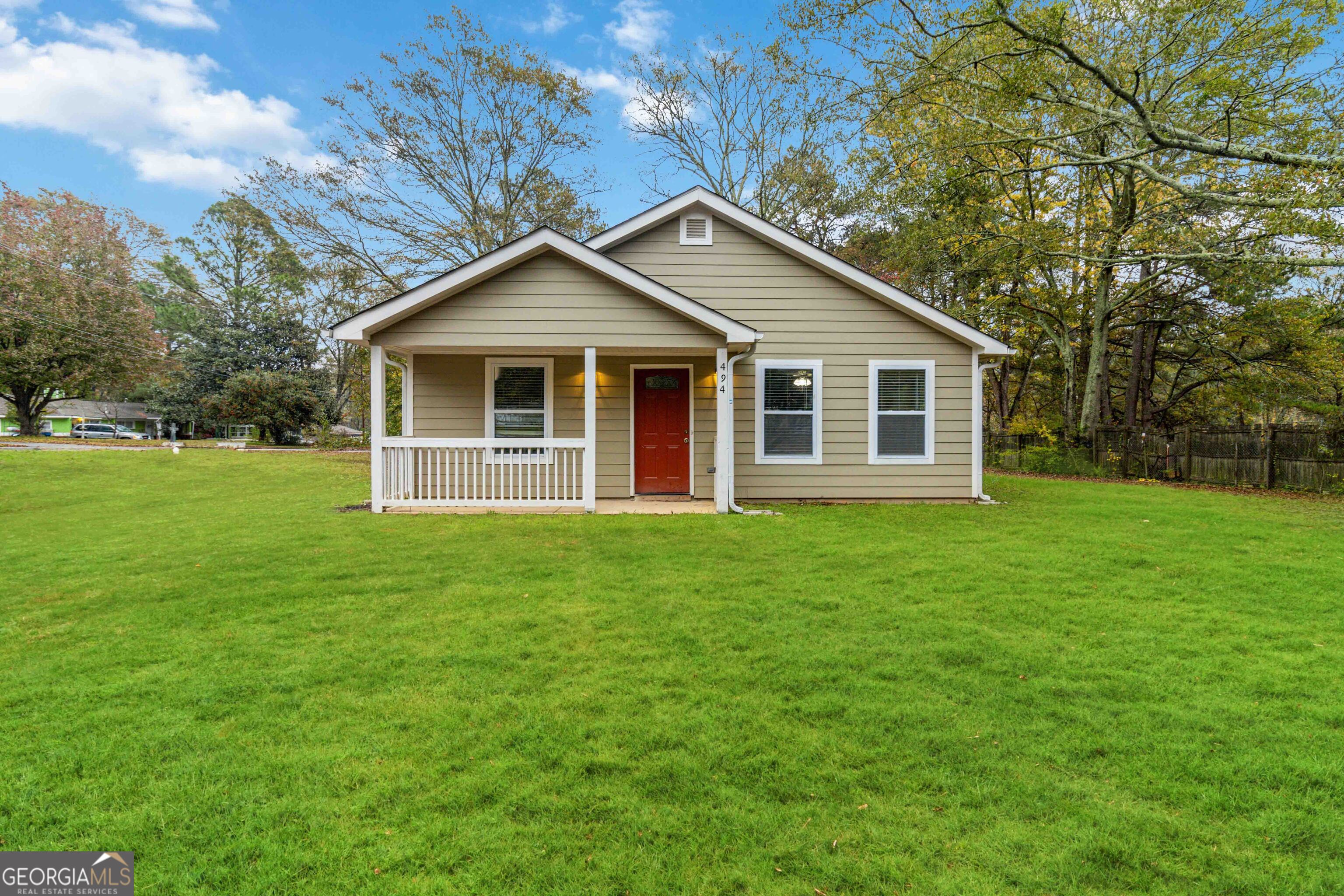 a view of a house with yard and tree s