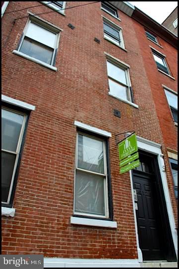 a brick building with a door and windows