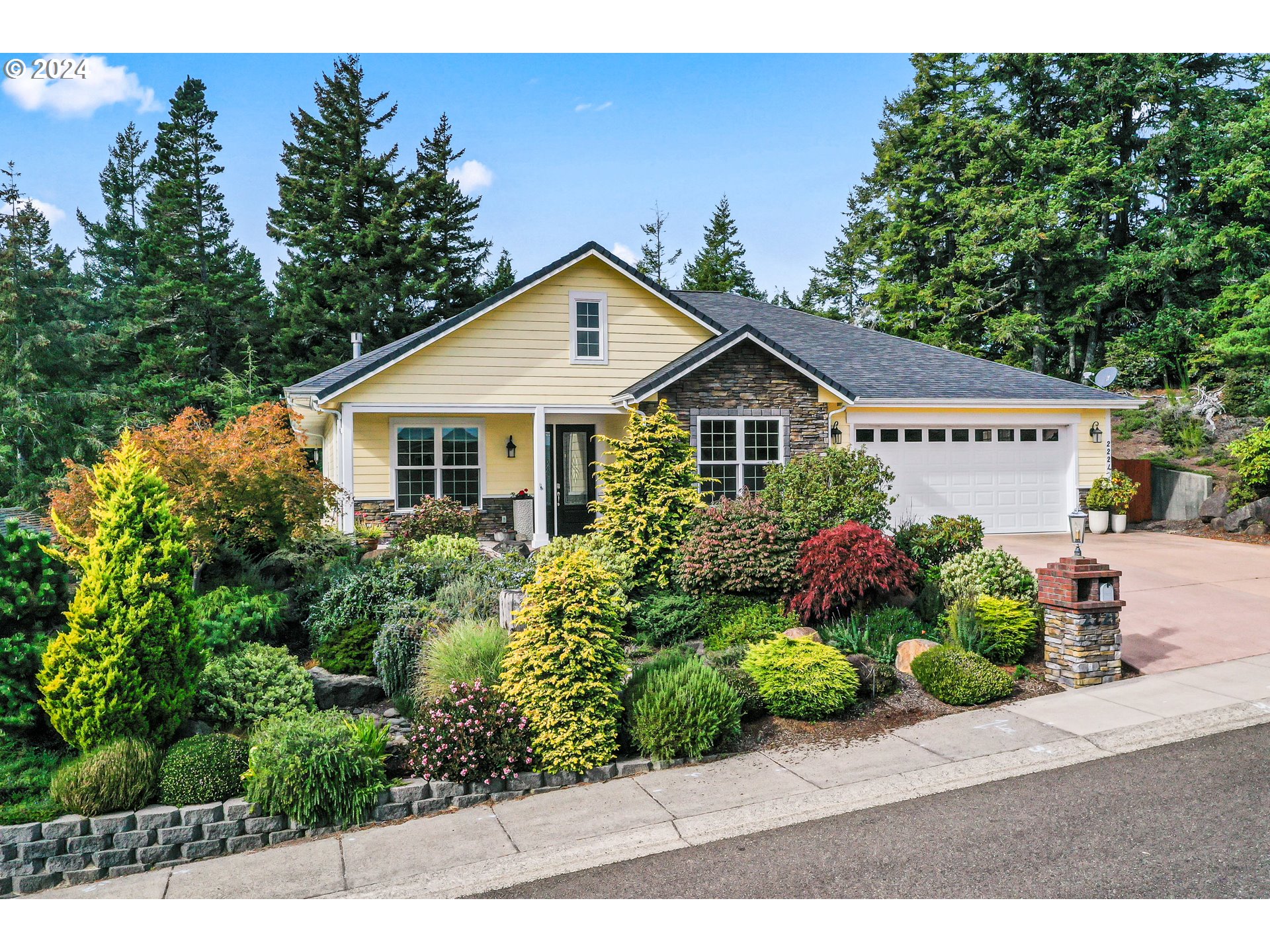 a view of a house with a small yard and potted plants