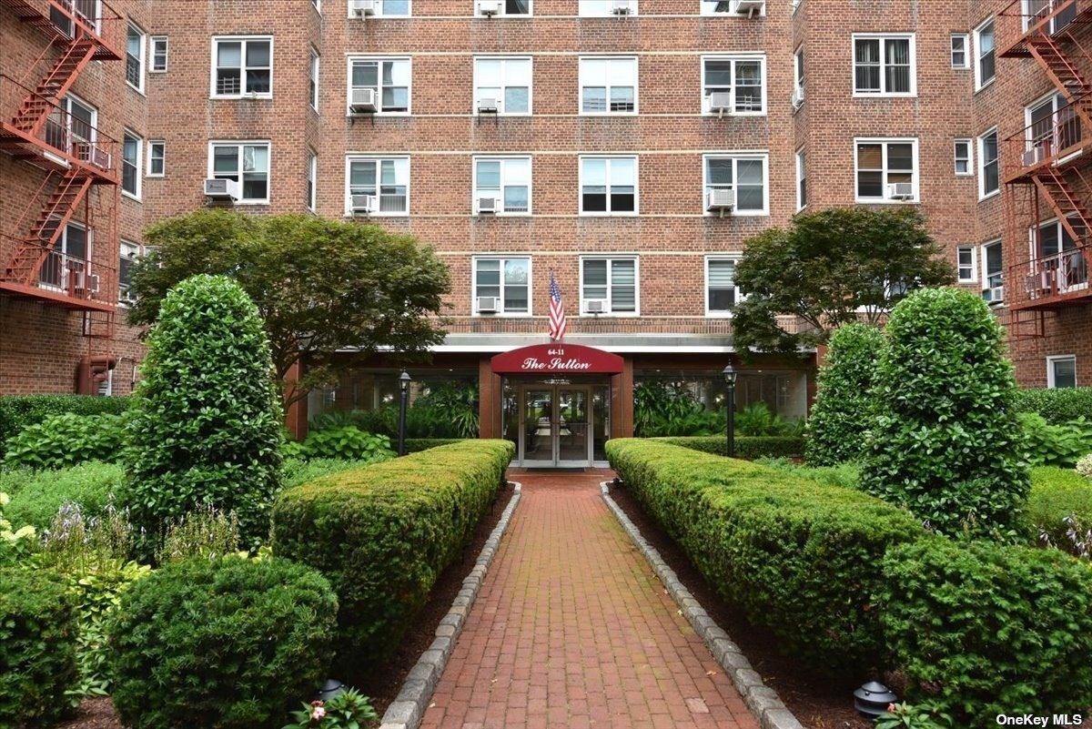 a view of a brick building next to a yard