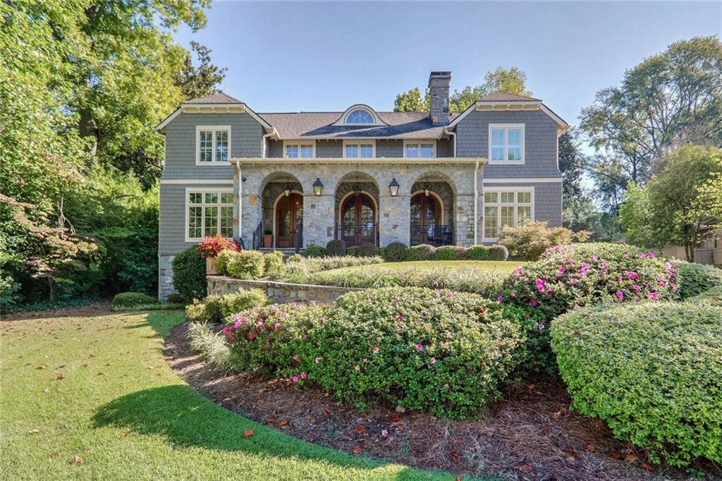 a front view of a house with a garden