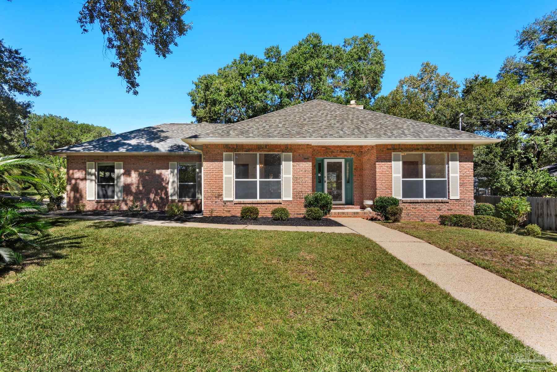 a front view of a house with yard patio and green space