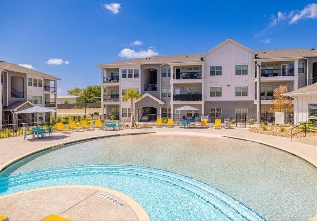 a view of swimming pool with outdoor seating