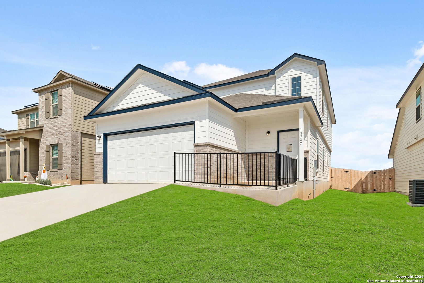 a view of a house with a yard and deck