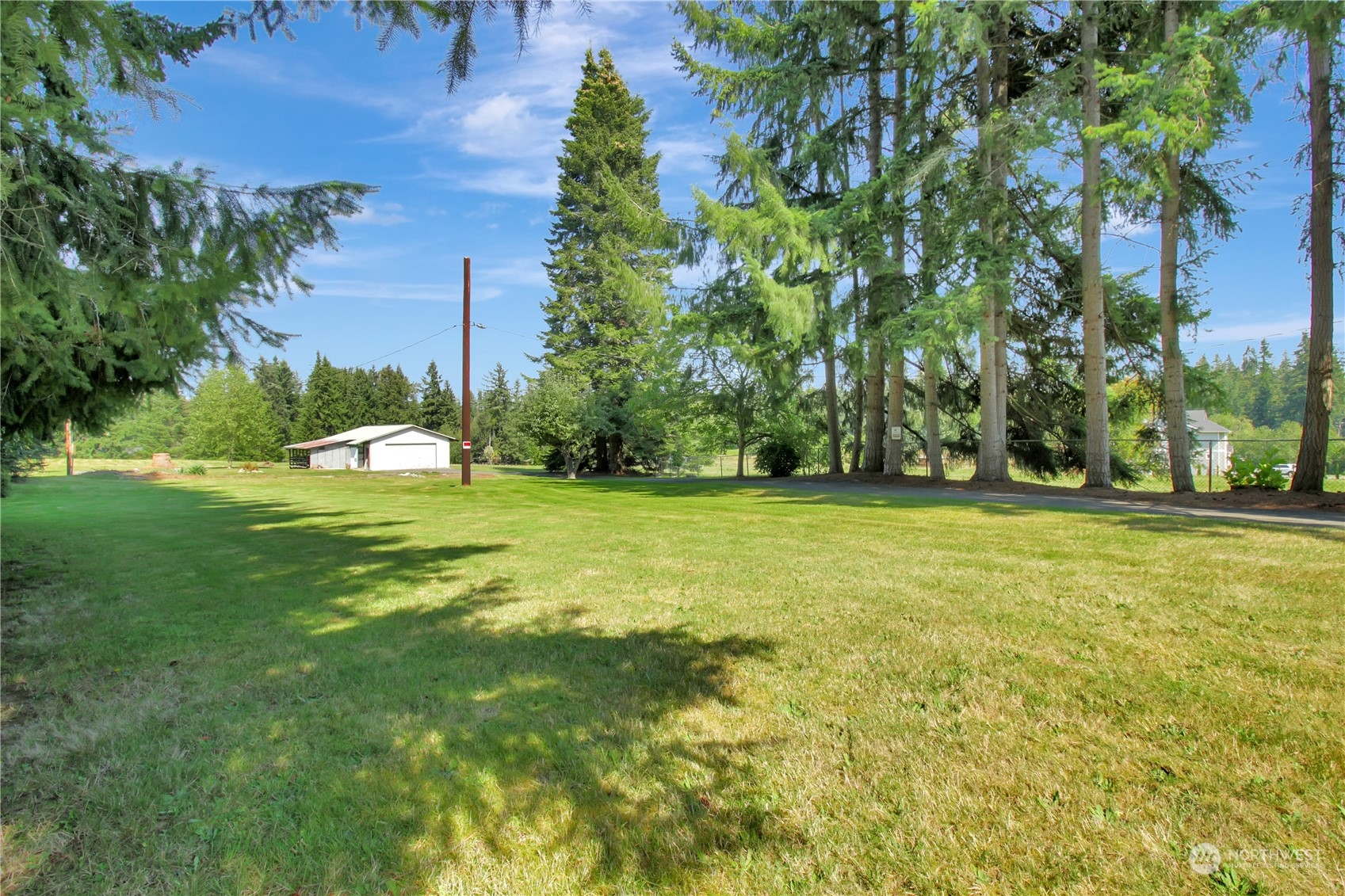 a view of a field of grass and trees