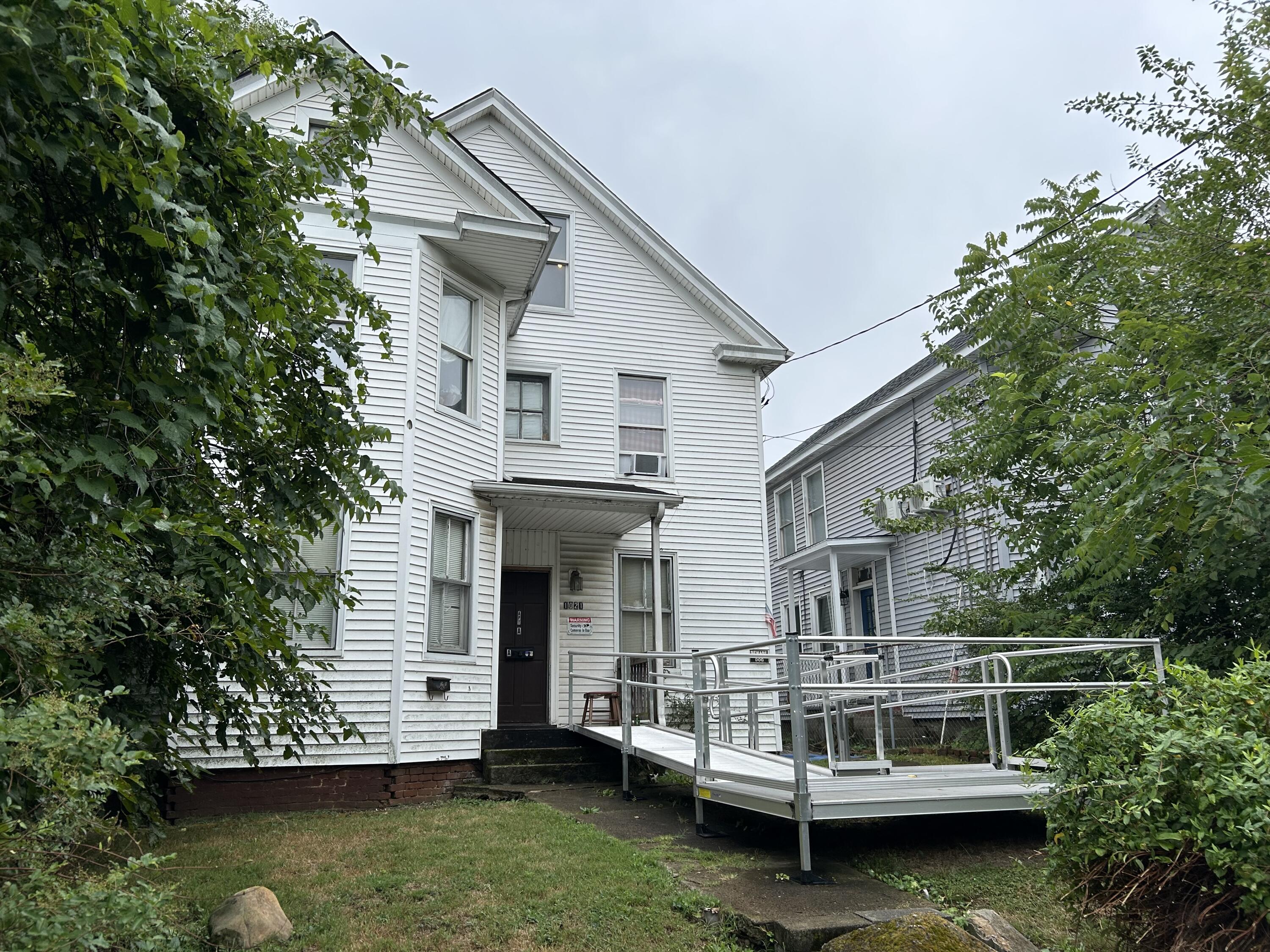 a view of house with yard in front of it