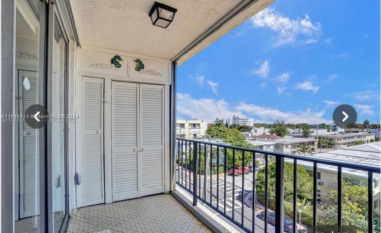 a view of a balcony with furniture