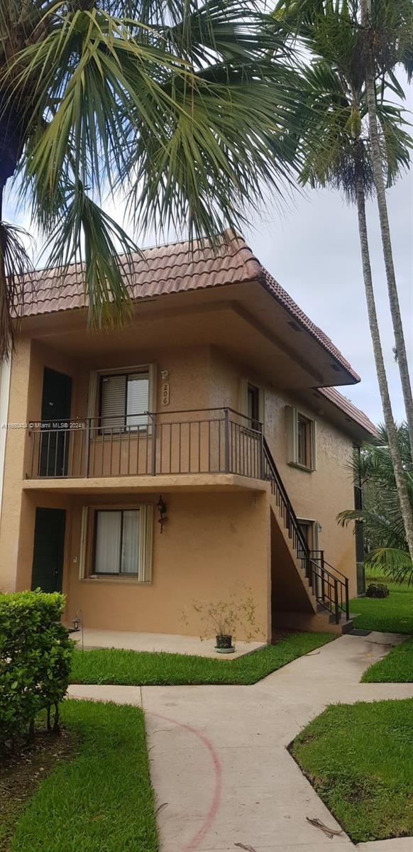 a house that has a tree in front of the house