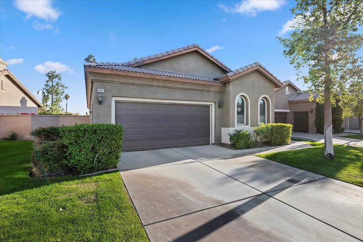 a front view of a house with a yard and garage