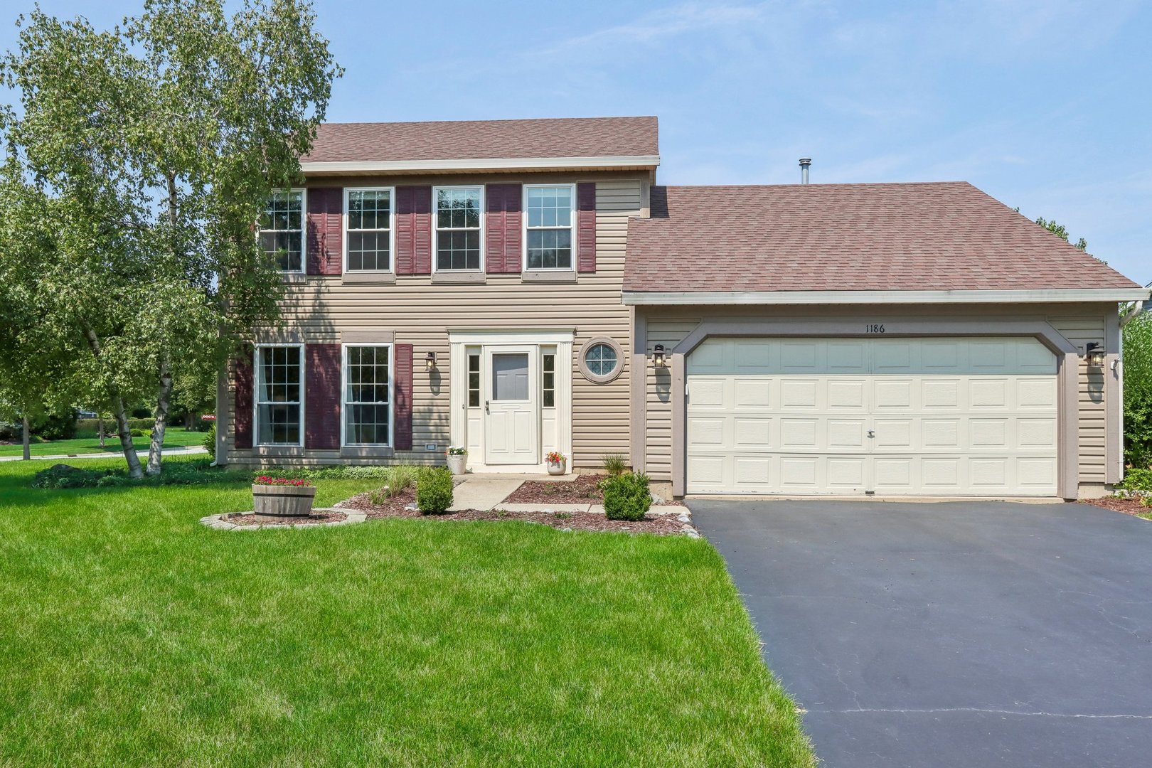 a front view of a house with a yard and garage