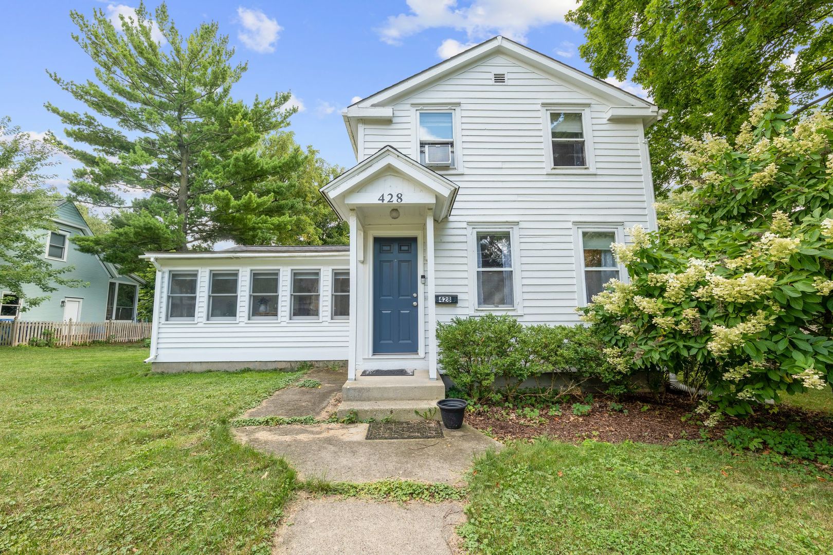 a front view of a house with a yard and porch