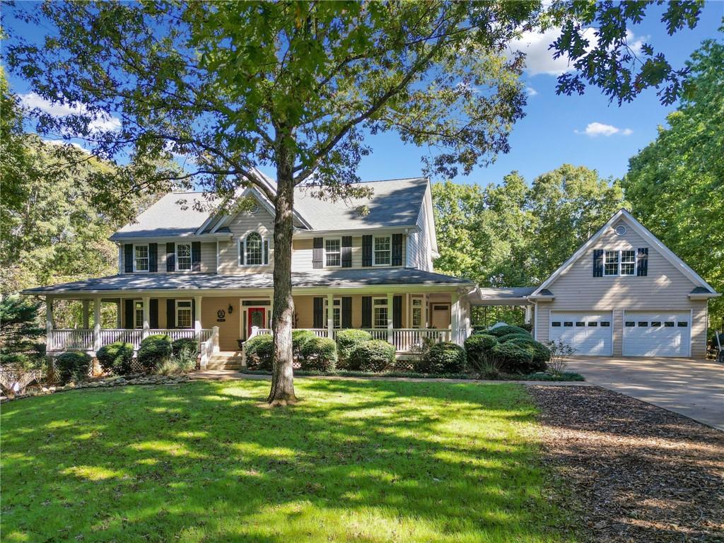 a front view of a house with a garden