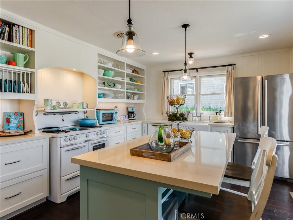 a kitchen with a table chairs stove and cabinets