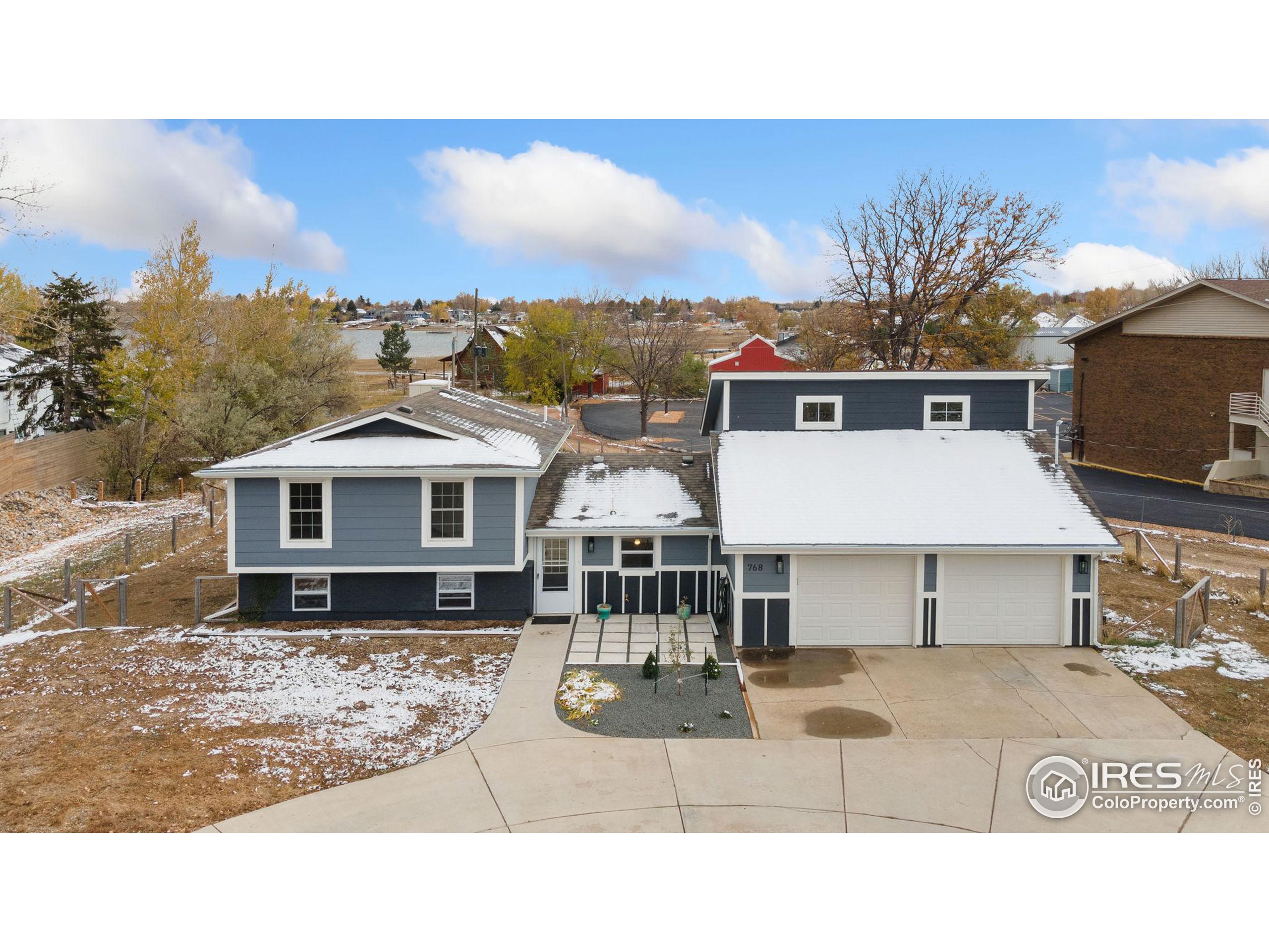 a aerial view of a house with a yard