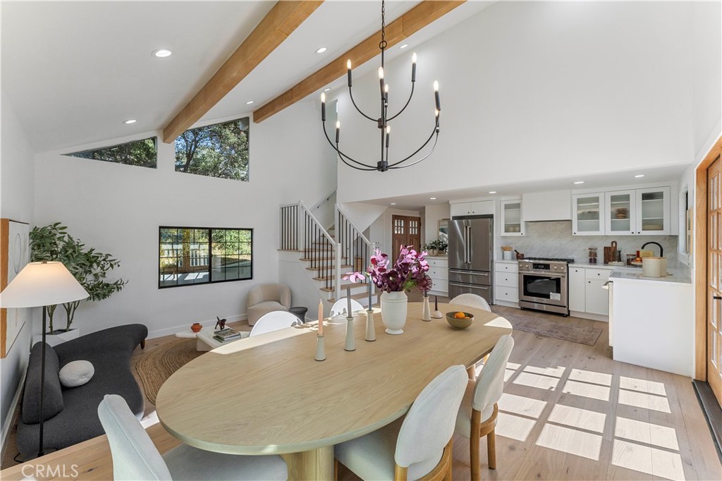 a view of a dining room with furniture and chandelier