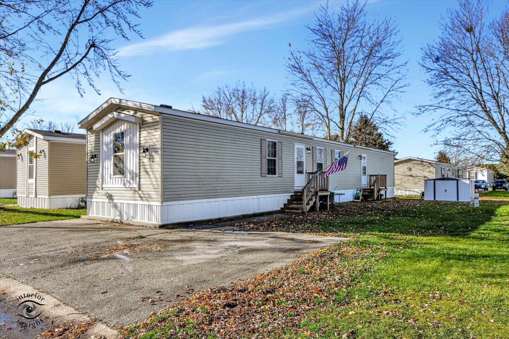 a view of a house with a yard and large tree