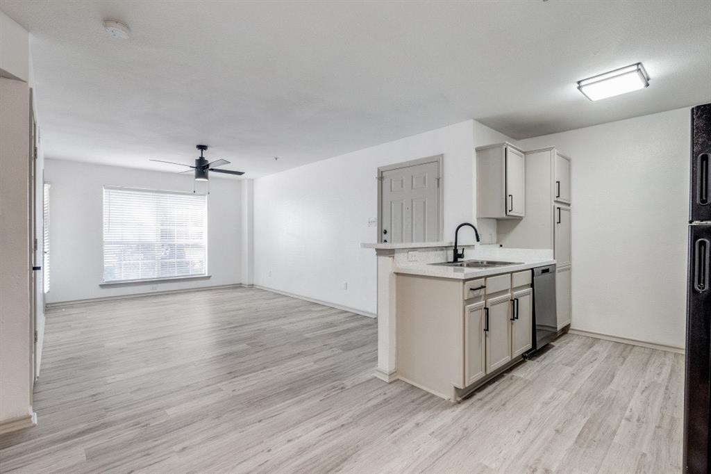 a kitchen with stainless steel appliances granite countertop a sink stove and wooden floors