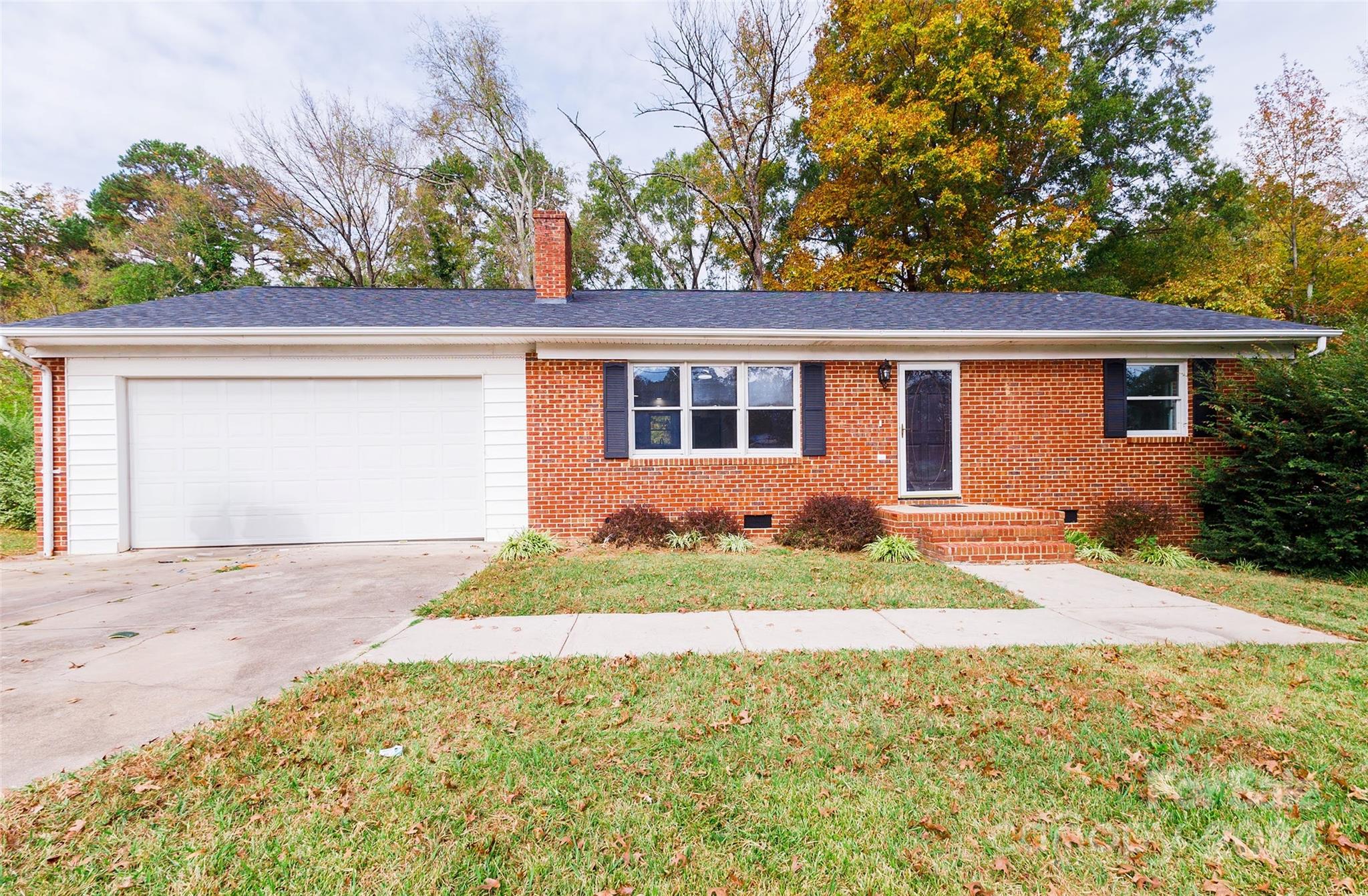 front view of a house next to a yard