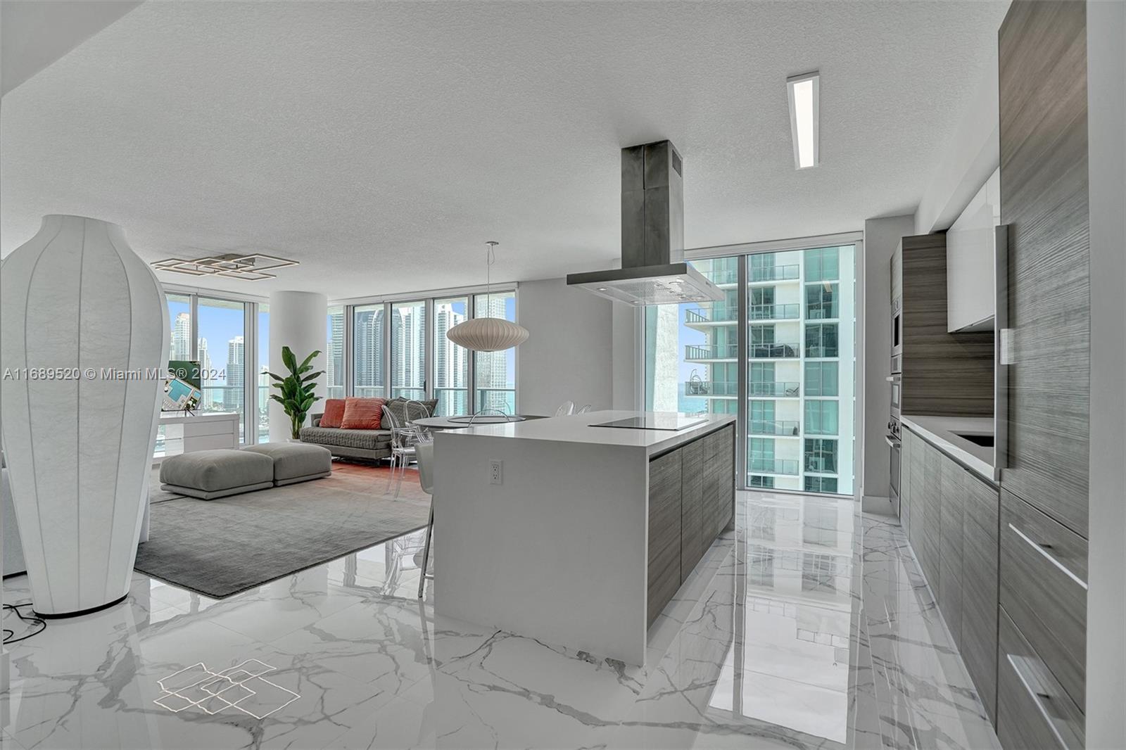 a kitchen with stainless steel appliances kitchen island granite countertop a table and chairs in it