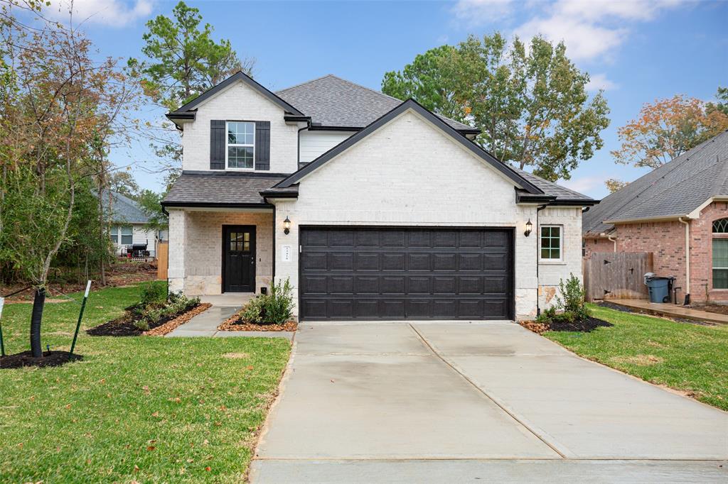 a front view of a house with a yard and garage