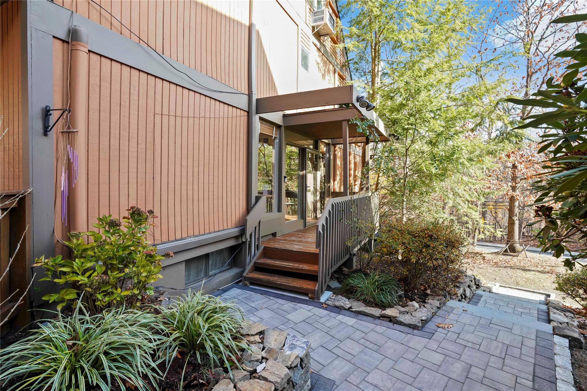 View of exterior entry featuring a wooden deck