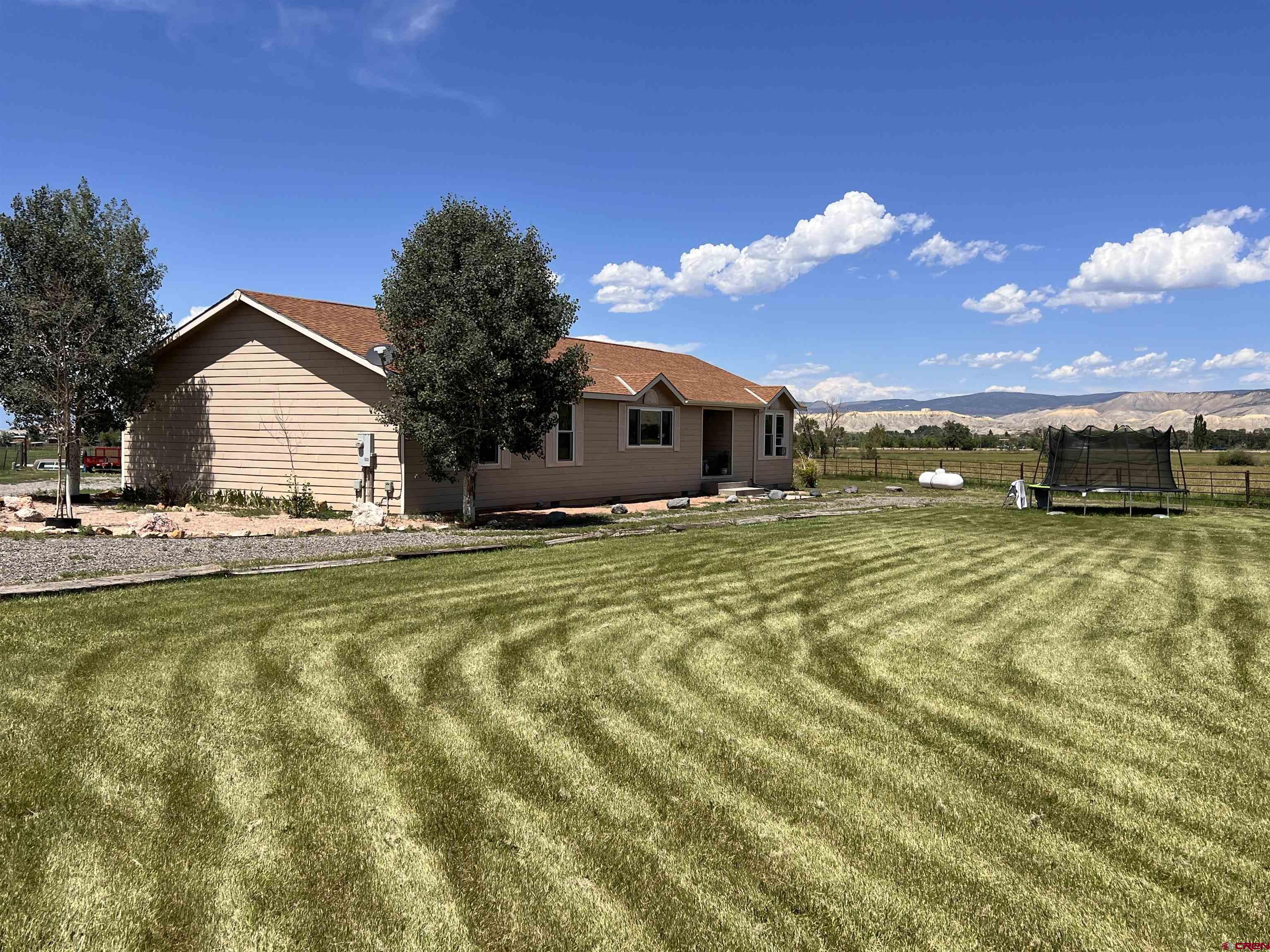 a view of a house with swimming pool and a yard