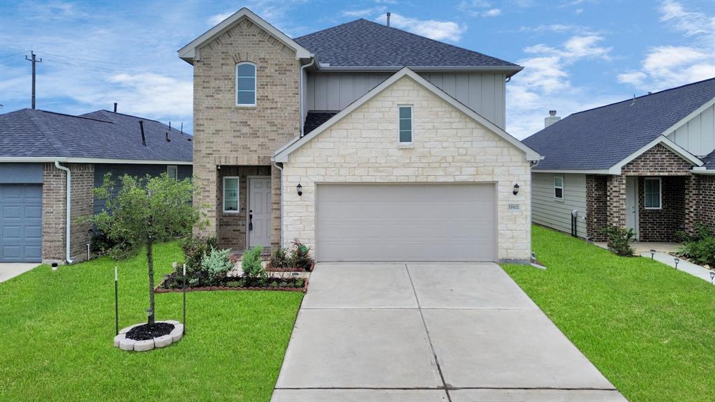 a front view of a house with a yard and garage