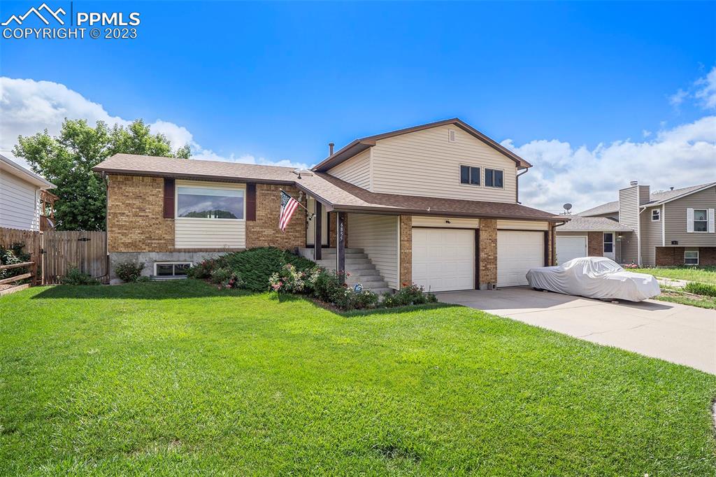 a view of a house with a yard and garage