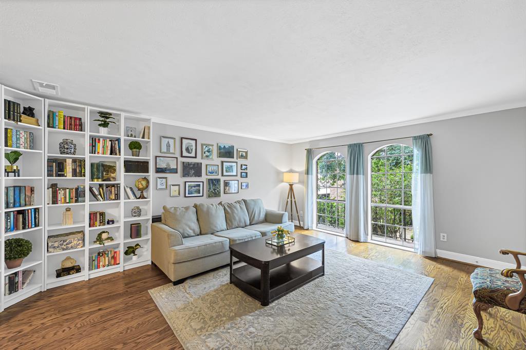 a living room with furniture and a book shelf