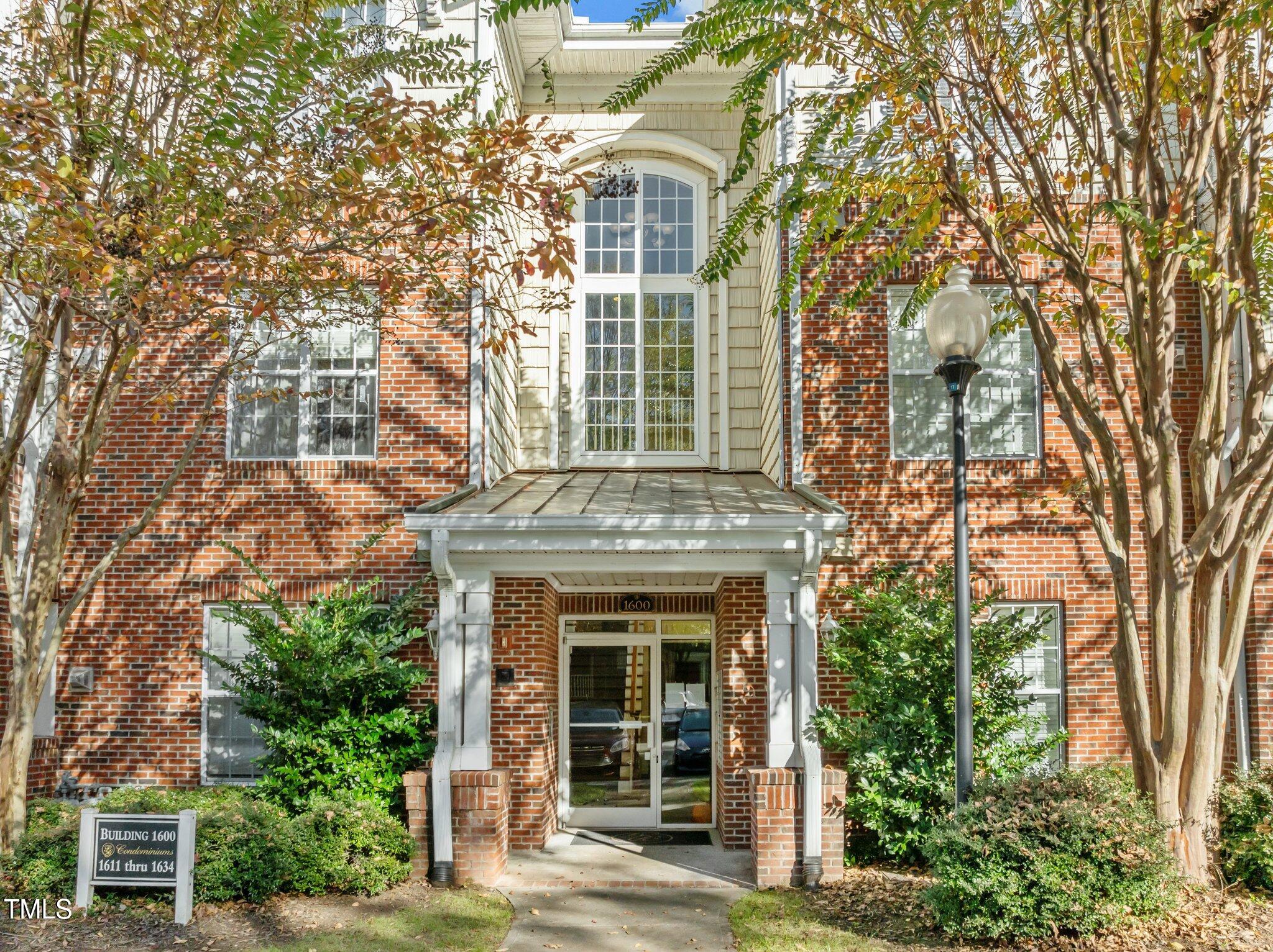 front view of a brick house with a large windows