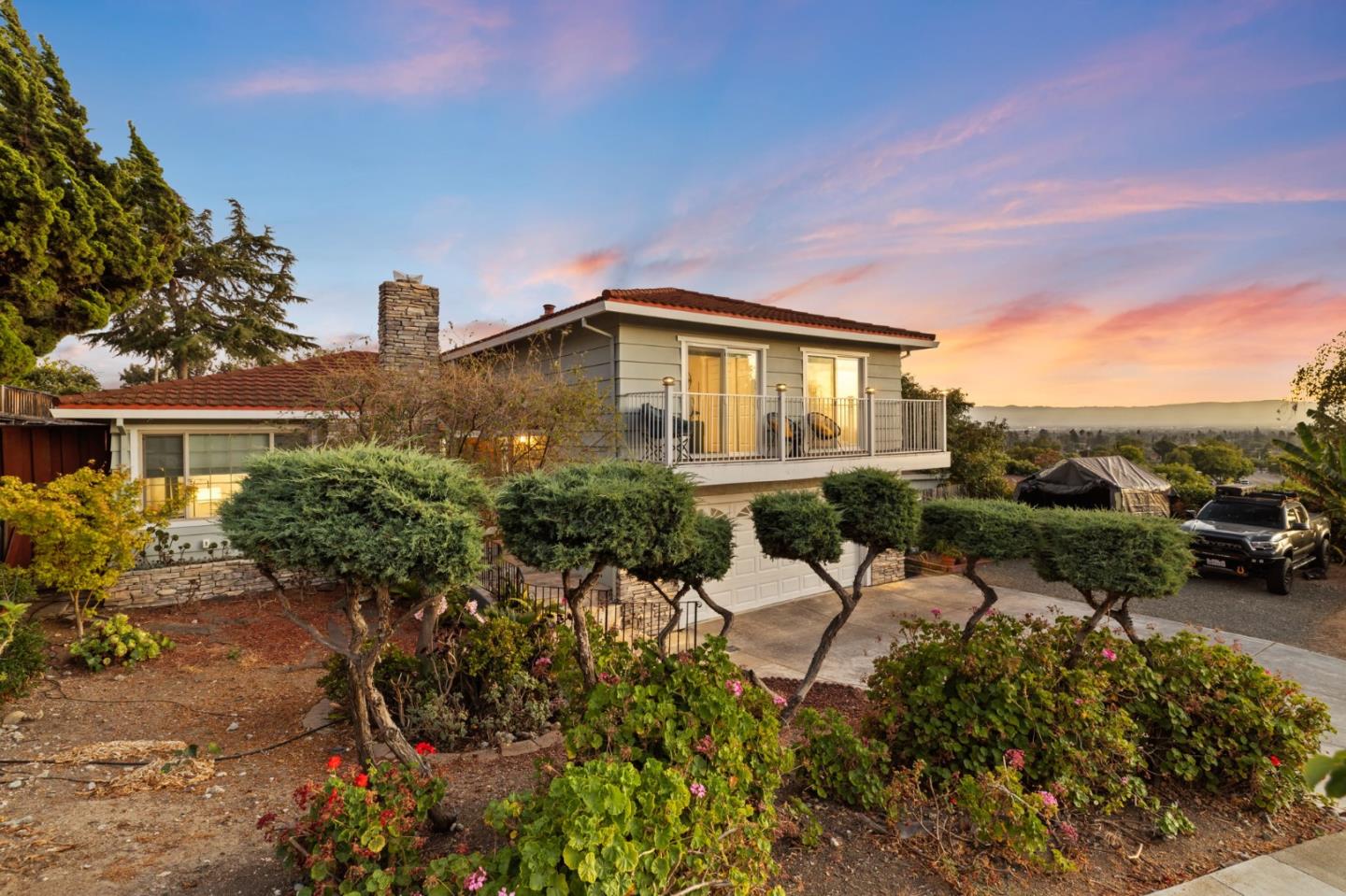 a view of a house with a yard and sitting area